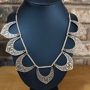 Gold Tone open crescent design statement necklace features